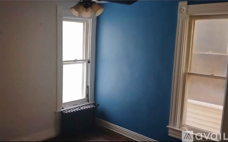 A room with blue walls and a window.