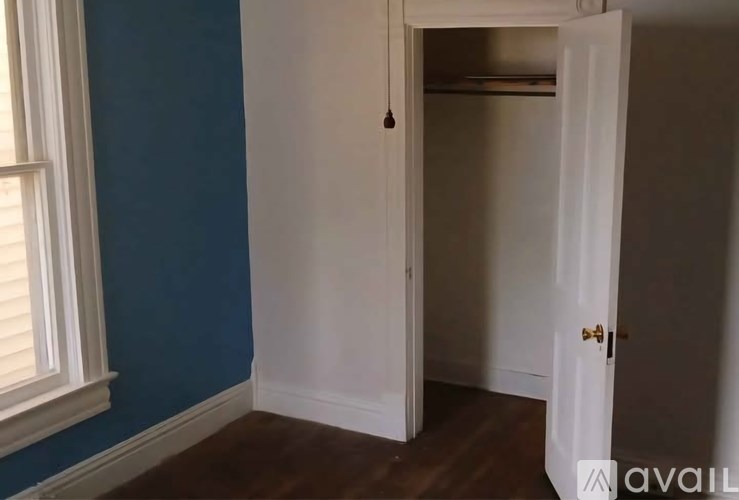 A room with a white door and a window.