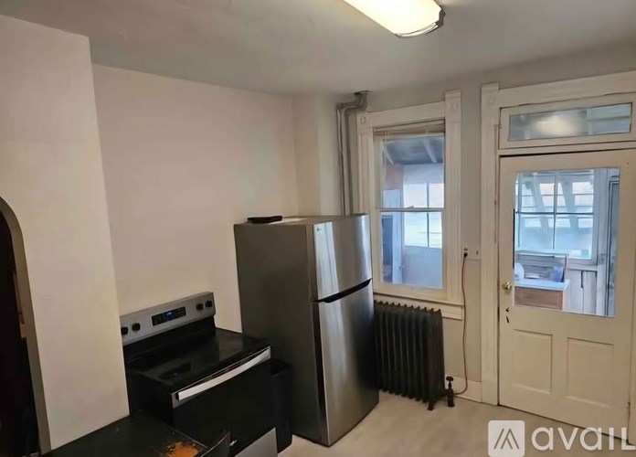 A kitchen with a black stove top oven and a black fridge.