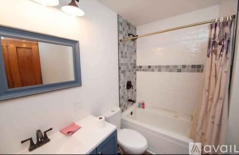 A bathroom with a toilet, sink, and shower.