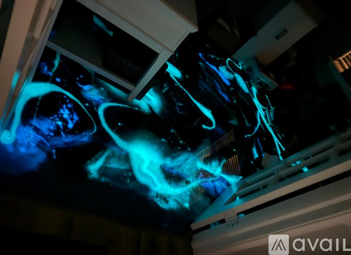 A computer monitor displays a blue and black abstract image.