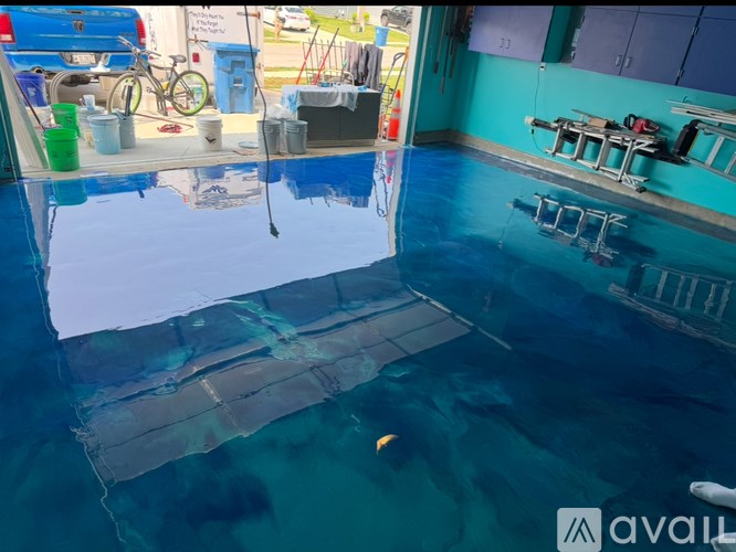 A room with a blue wall and a pool table.
