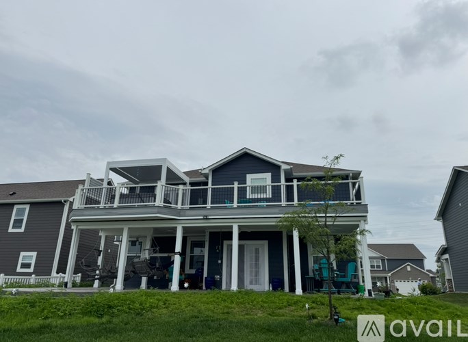 A house with a balcony and a sign that says "available" in the foreground.