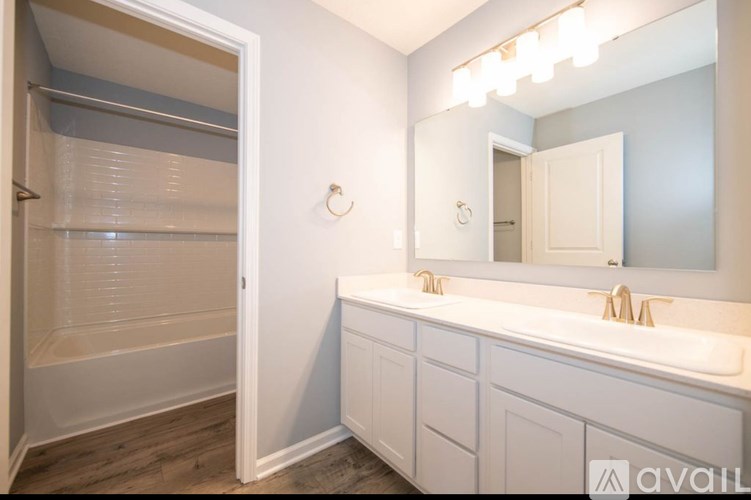 A bathroom with a white sink and a white bathtub.