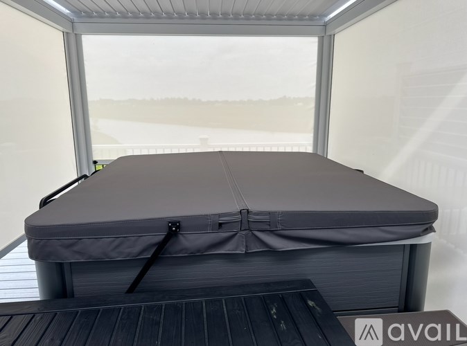 A grey inflatable mattress with a grey cover and black straps.