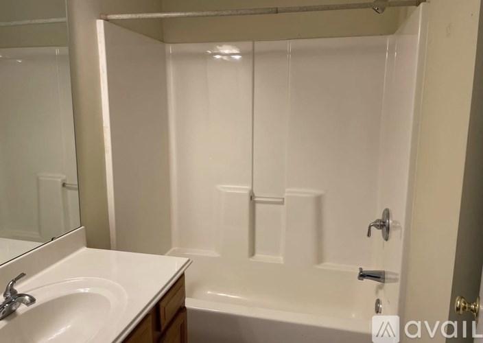 A white bathroom with a sink and a bathtub.