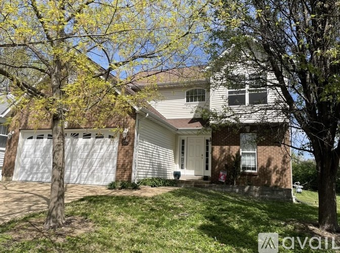 A house with a white garage door is for sale.