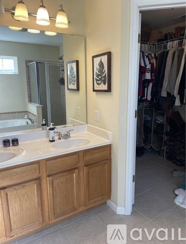 A bathroom with a double sink and a mirror above it.