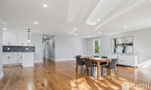 A modern kitchen with a dining table and chairs.