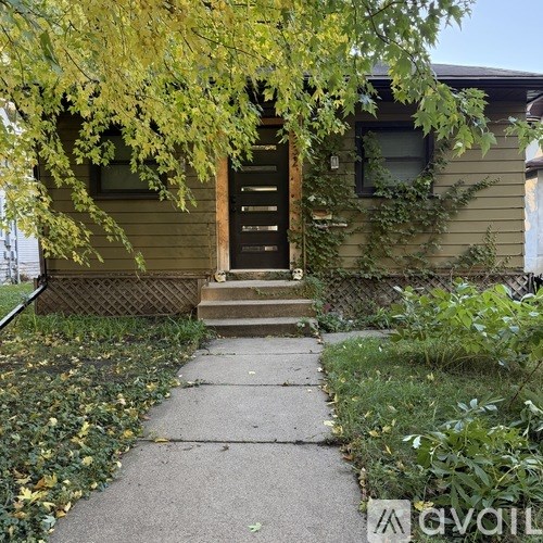 A house with a brown door and a small front yard.