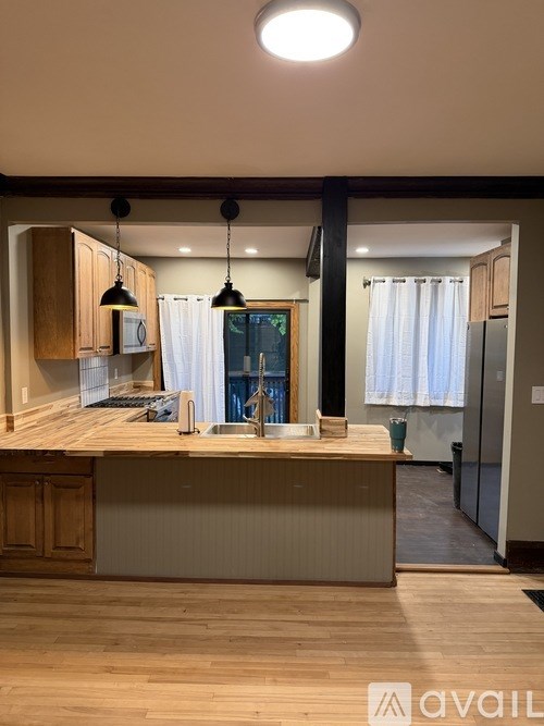 A black door with a handle and a window above it.