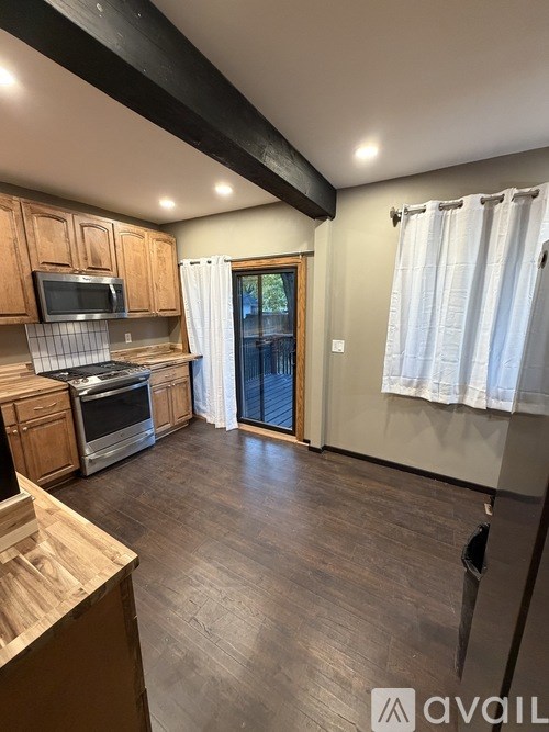 A room with wooden flooring and a door.