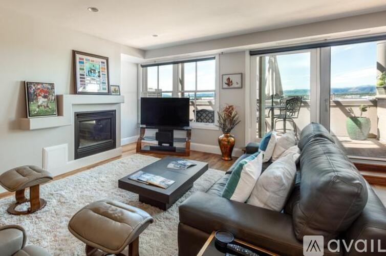 A living room with a fireplace, a couch, and a television.