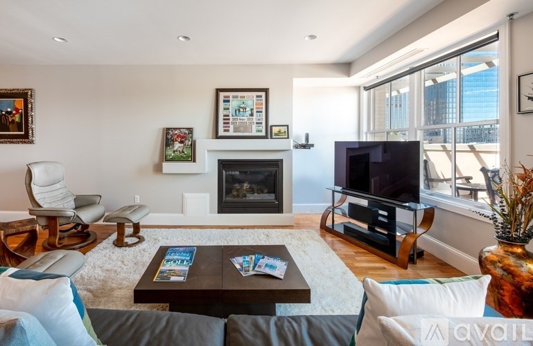 A living room with a fireplace and a television.