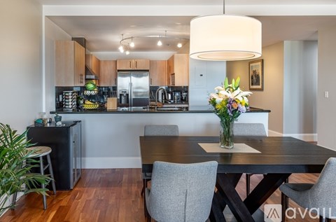 A modern kitchen with a dining table set for four.