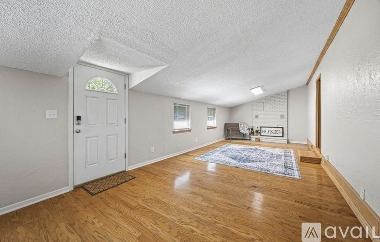 A room with wooden floors and a white door.