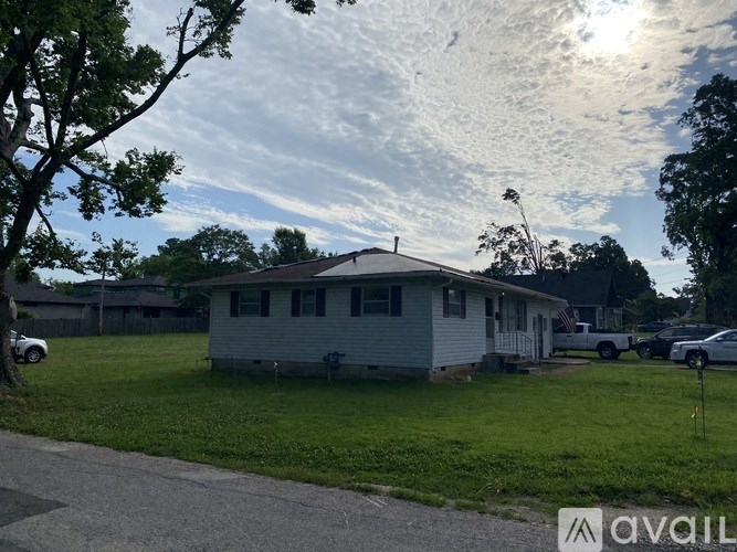 A house with a car parked in front of it.