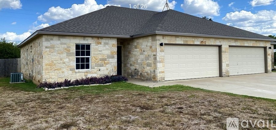 A two-car garage with a stone exterior is for sale.