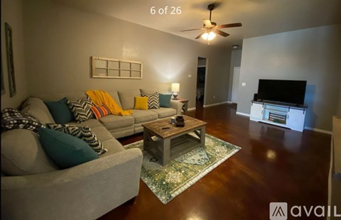 A living room with a grey couch and a coffee table.