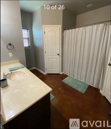 A bathroom with a white sink and a white door.