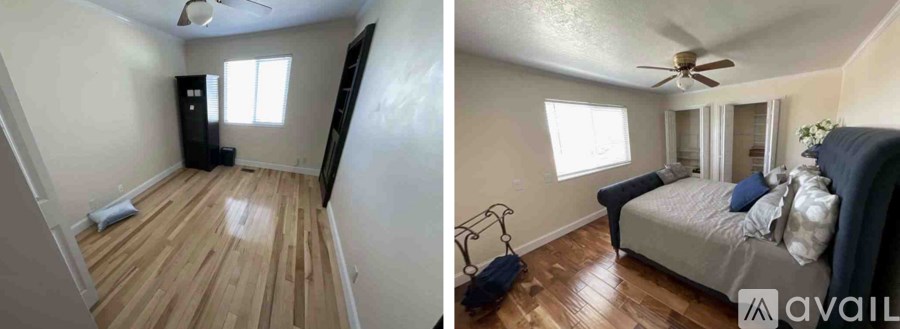 A room with wooden floors and a bed with pillows.