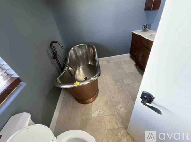 A bathroom with a toilet, a sink, and a cabinet.