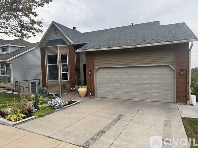 A house with a grey garage door and a grey roof.