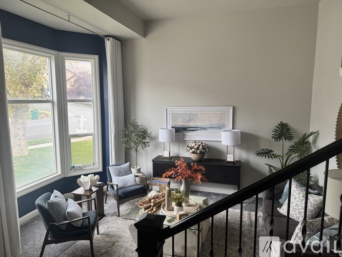 A living room with a fireplace and a staircase.