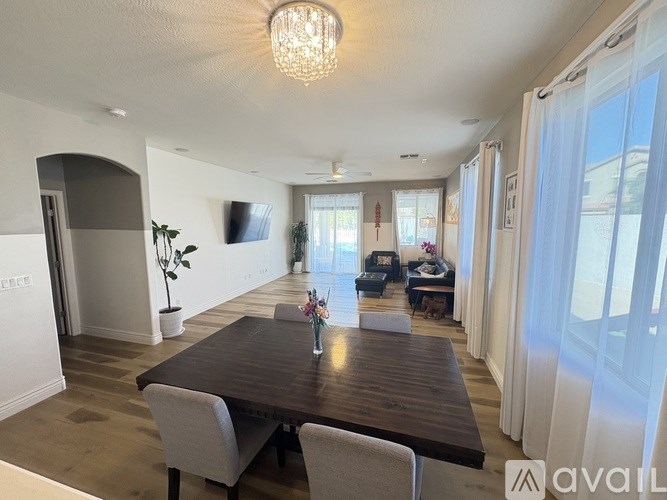 A dining room with a wooden table and chairs.