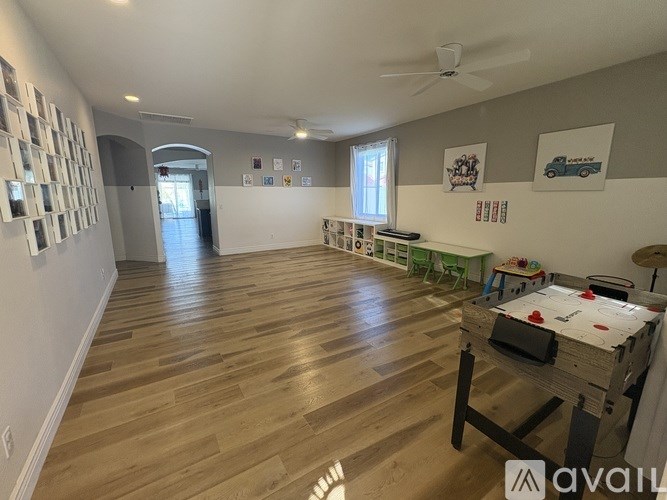 A room with wooden flooring and a bed in it.