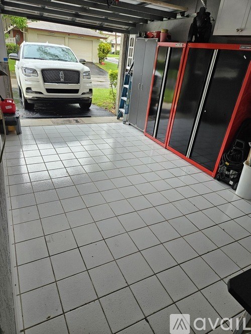 A white SUV is parked in a garage.