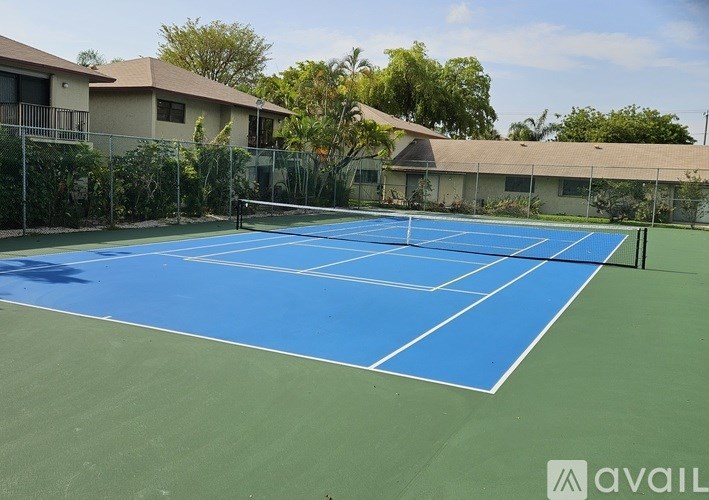 A tennis court with a net and a sign that says "available".