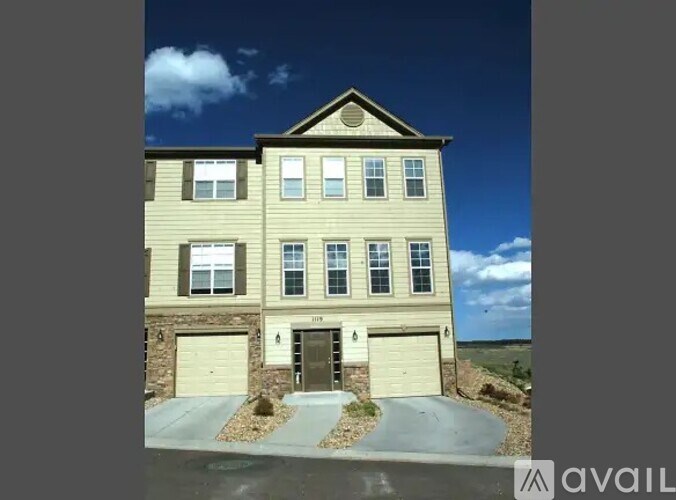A two-story house with a garage is available for sale.