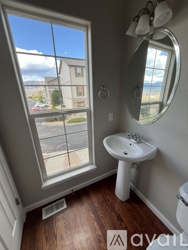 A bathroom with a window overlooking a street.