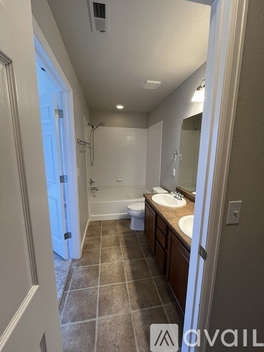 A bathroom with a white tub and sink.
