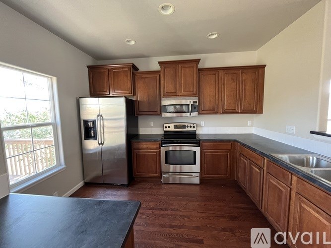 A kitchen with wooden cabinets and stainless steel appliances.