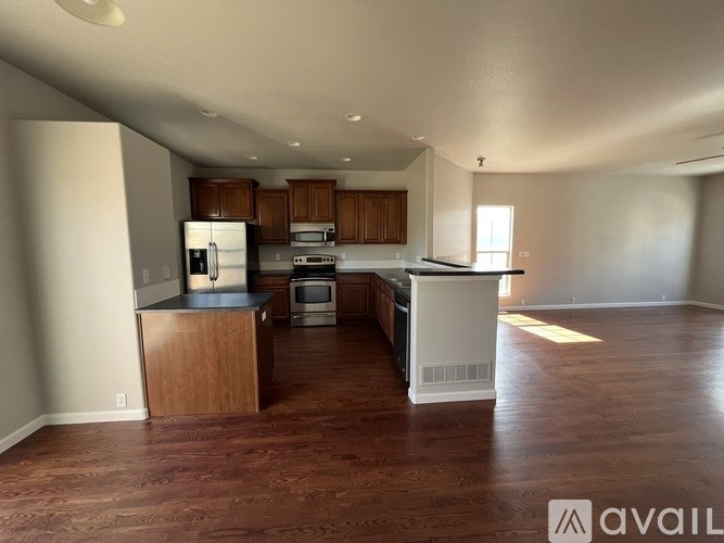 A kitchen with wooden cabinets and a white island.