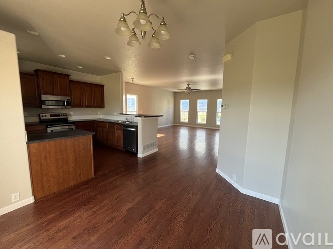 A kitchen with wooden floors and a white ceiling.