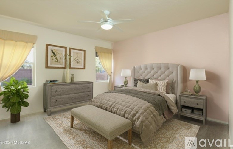 A bedroom with a large bed, a dresser, and a ceiling fan.