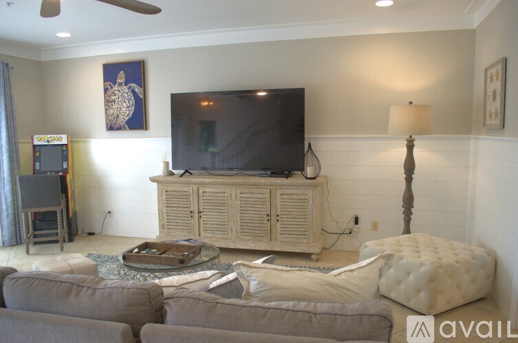 A living room with a television, a couch, and a coffee table.