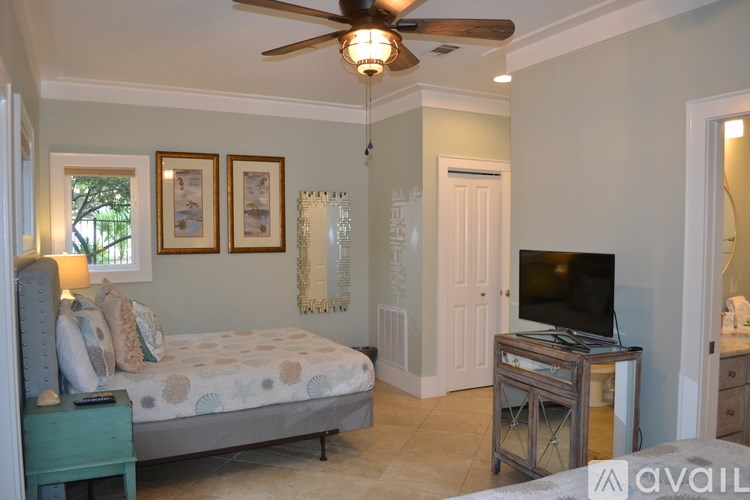 A bathroom with a tiled shower and a door.