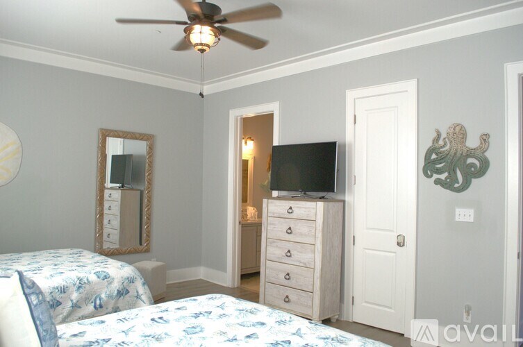 A bedroom with a bed, dresser, and mirror.