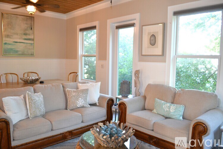 A living room with a large sectional sofa and a coffee table in front of it.