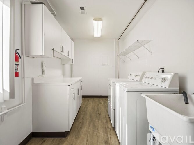 A laundry room with a washer and dryer stacked together.