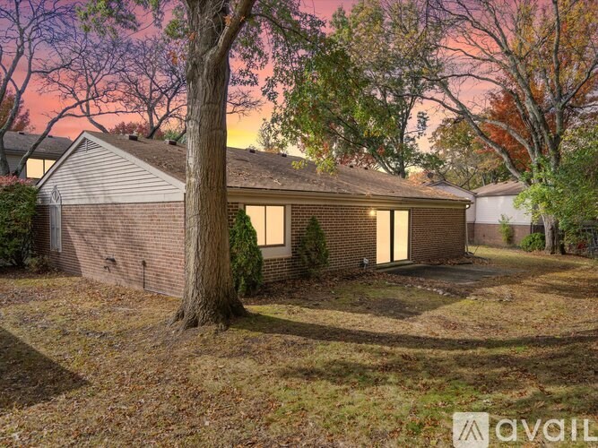 A house with a tree in front of it.