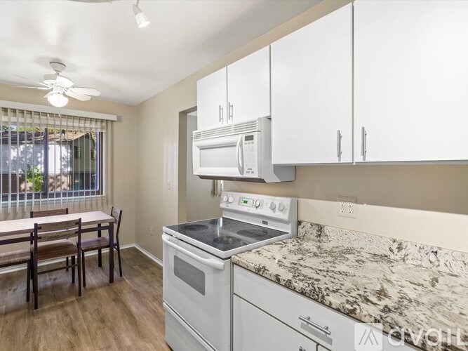 A kitchen with a stove, oven, and cabinets.