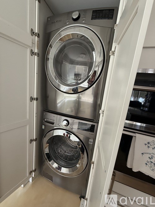 A washing machine is in a cabinet.