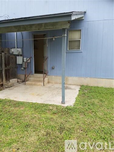 A blue building with a door and a window.