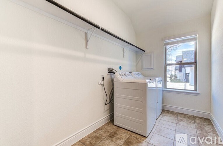 A small room with a window and a white cabinet.