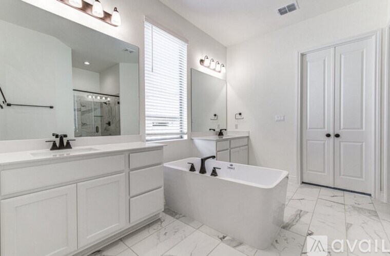 A white bathroom with a large tub and a vanity.
